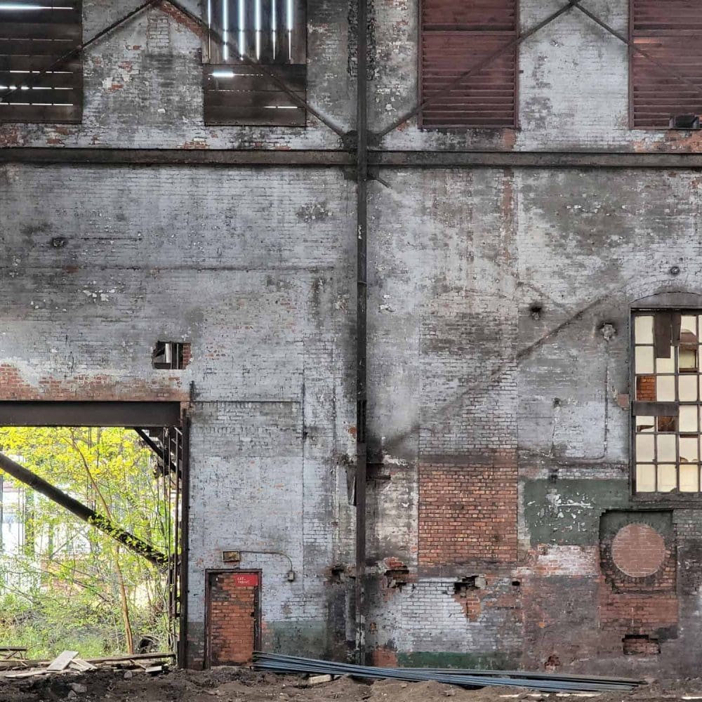 Abandoned industrial building with cracked brick walls.