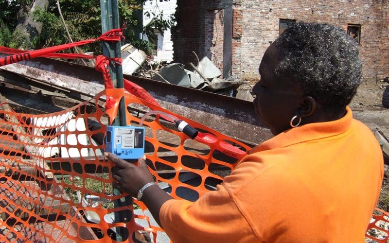 Person inspecting construction site with a handheld device.