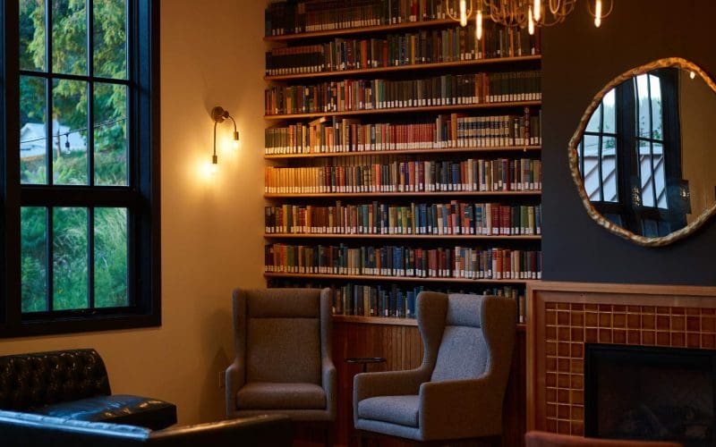 Cozy library corner with armchairs and bookshelves.