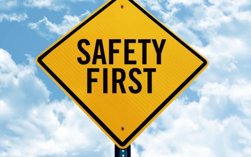 Safety First sign against a cloudy sky background.