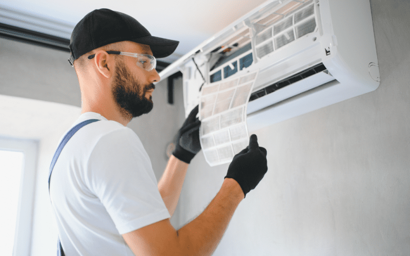 Technician servicing an air conditioning unit.